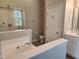 Bright bathroom with a large soaking tub, a glass enclosed shower, and tile floors at 5033 Amber Clay Ln, Raleigh, NC 27612
