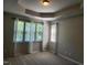 A spacious bedroom with large windows and tray ceilings provides lots of natural light at 5033 Amber Clay Ln, Raleigh, NC 27612