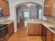 Open kitchen with wood cabinets, stainless appliances, and hardwood flooring overlooking the living space at 5033 Amber Clay Ln, Raleigh, NC 27612