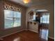 Inviting kitchenette with an archway, hardwood floors, and floral valance at 5033 Amber Clay Ln, Raleigh, NC 27612