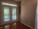 Bright room with hardwood floors, featuring a door with blinds and built in shelving at 5033 Amber Clay Ln, Raleigh, NC 27612