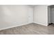 Empty bedroom with base trim, wood-look floors, and fresh neutral paint at 505 Gooseneck Dr # A1, Cary, NC 27513