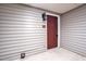A-1 Entrance door with dark wood-look door and matching sconce at 505 Gooseneck Dr # A1, Cary, NC 27513