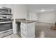 Eat-in kitchen includes stainless appliances, granite countertops, and wood-look floors at 505 Gooseneck Dr # A1, Cary, NC 27513