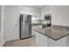 Kitchen features stainless steel appliances, granite countertops, and white cabinetry at 505 Gooseneck Dr # A1, Cary, NC 27513