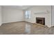 Living room featuring a fireplace with mantel, tile detail, and wood-look floors at 505 Gooseneck Dr # A1, Cary, NC 27513