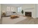 Cozy living room features a fireplace, neutral decor, and wood-look flooring at 505 Gooseneck Dr # A1, Cary, NC 27513