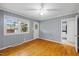 Cozy bedroom with wood paneling, hardwood floors, and ample natural light for a comfortable retreat at 515 Oakwood Ln, Graham, NC 27253