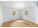 Bright dining room with hardwood floors and elegant lighting, ideal for entertaining guests at 515 Oakwood Ln, Graham, NC 27253