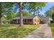 A lovely brick home featuring a car port and a well-maintained lawn at 515 Oakwood Ln, Graham, NC 27253