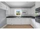 Functional kitchen with white cabinets and a window over the sink, perfect for home cooking at 515 Oakwood Ln, Graham, NC 27253