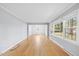 Spacious living room with hardwood floors and large windows, offering plenty of natural light at 515 Oakwood Ln, Graham, NC 27253