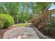 Beautiful backyard featuring a stone patio, lush landscaping, and vibrant roses at 528 Bankhead Dr, Cary, NC 27519