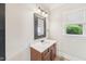 Cozy bathroom with wood cabinets, decorative mirror, and natural light provides a comfortable space at 528 Bankhead Dr, Cary, NC 27519