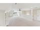 Large bonus room with neutral carpet, a ceiling fan, staircase, and built-in shelving at 528 Bankhead Dr, Cary, NC 27519