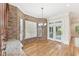 Bright breakfast nook with brick walls, bay windows, and access to the outdoor patio at 528 Bankhead Dr, Cary, NC 27519