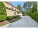 Spacious driveway leading to a three-car garage, surrounded by lush landscaping at 528 Bankhead Dr, Cary, NC 27519