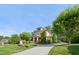 Elegant two-story home with lush landscaping, a stone retaining wall, and long driveway at 528 Bankhead Dr, Cary, NC 27519