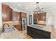 Gourmet kitchen with granite countertops, stainless appliances and a central island cooktop at 528 Bankhead Dr, Cary, NC 27519