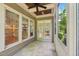 Covered screened-in porch with stone tiles, paneled ceiling and view of foliage at 528 Bankhead Dr, Cary, NC 27519