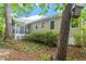 Backyard featuring a screened-in porch, mature trees, and lush landscaping at 5420 Royal Troon Dr, Raleigh, NC 27604