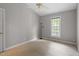 Neutral bedroom with carpet, large window with treed view, and ceiling fan at 5420 Royal Troon Dr, Raleigh, NC 27604