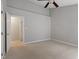 Neutral bedroom featuring a ceiling fan, carpeted floor, and closet entrance at 5420 Royal Troon Dr, Raleigh, NC 27604