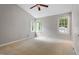 Carpeted bedroom with bright windows, vaulted ceilings, and a modern ceiling fan at 5420 Royal Troon Dr, Raleigh, NC 27604