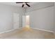 Bright, airy bedroom with neutral walls, ceiling fan, and multiple doorways at 5420 Royal Troon Dr, Raleigh, NC 27604