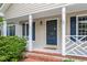 Inviting front porch with classic columns, charming details, and brick steps leading to the entryway at 5420 Royal Troon Dr, Raleigh, NC 27604