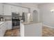 Well-lit kitchen with white cabinets, stainless steel appliances, and a granite-topped island at 5420 Royal Troon Dr, Raleigh, NC 27604