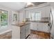 Bright kitchen featuring white cabinets, granite countertops, stainless steel appliances and center island at 5420 Royal Troon Dr, Raleigh, NC 27604