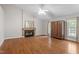 Bright living room features laminate flooring, fireplace with decorated mantel and ceiling fan at 5420 Royal Troon Dr, Raleigh, NC 27604