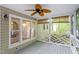Relaxing screened porch with ceiling fan and views of the surrounding yard at 5420 Royal Troon Dr, Raleigh, NC 27604