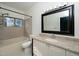 Well-lit bathroom with a large mirror, vanity, and a shower-tub combo at 6011 Winterpointe Ln # 205, Raleigh, NC 27606