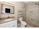 Bathroom featuring a granite vanity, tile shower, and a framed mirror at 6011 Winterpointe Ln # 205, Raleigh, NC 27606