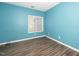 Bedroom with laminate flooring and a bright window for ample natural light at 6011 Winterpointe Ln # 205, Raleigh, NC 27606