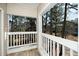 Exterior view of a wooden deck with white railings overlooking a wooded backyard at 6011 Winterpointe Ln # 205, Raleigh, NC 27606