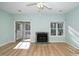 Inviting living room featuring a fireplace and a sliding glass door to outdoor deck at 6011 Winterpointe Ln # 205, Raleigh, NC 27606