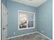 Brightly lit room featuring tiled floors, a large window and fresh paint at 6011 Winterpointe Ln # 205, Raleigh, NC 27606