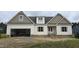 Charming new construction with a two-car garage, inviting front porch, and a mix of white and brown exterior at 65 Sanders Farm Dr, Smithfield, NC 27577