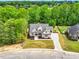 Beautifully landscaped two-story brick home nestled in a wooded area offering privacy and curb appeal at 669 Balmoral St, Clayton, NC 27520