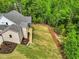 Backyard view showcasing a newly sodded lawn and brick exterior, blending beauty with outdoor enjoyment at 669 Balmoral St, Clayton, NC 27520