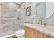 Elegant bathroom featuring a marble vanity, decorative mirror, and stylish glass-enclosed shower at 669 Balmoral St, Clayton, NC 27520