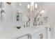 Bathroom featuring dual sinks, marble countertops, and vintage-style fixtures at 669 Balmoral St, Clayton, NC 27520