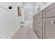 Bright bathroom with herringbone tile floor, white subway tile, and gray vanity at 669 Balmoral St, Clayton, NC 27520