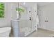 Bathroom features glass shower, tile floors, window, and custom cabinetry at 669 Balmoral St, Clayton, NC 27520