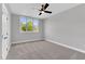 Neutral bedroom with gray walls, carpet, ceiling fan and a large window at 669 Balmoral St, Clayton, NC 27520