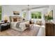 Serene bedroom with large windows, a sitting area, and a luxurious upholstered bed at 669 Balmoral St, Clayton, NC 27520