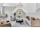 Cozy bonus room features dormer windows, plush seating, and stylish decor at 669 Balmoral St, Clayton, NC 27520